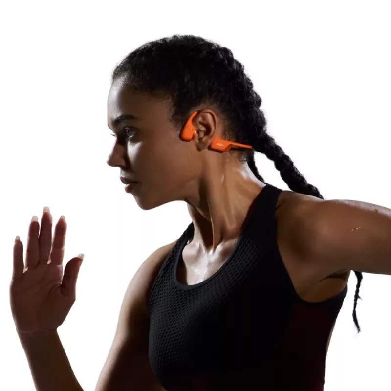 Kaulų laidumo ausinės Shokz OpenRun Pro 2 — binauralinės, belaidės Bluetooth 5.3, IP55, 12 val. veikimo, 150 mAh, oranžinės, užkabinamos už ausies