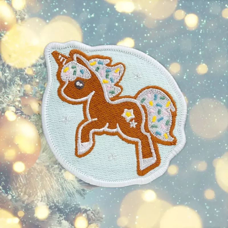 Ženkliukas LAUT MAGMOJI BADGE – Unicorn Cookie Christmas Edition, PVC ir silikonas, ruda/šviesiai mėlyna, 1 vnt.