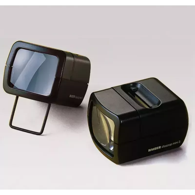Skaidrių projektorius KAISER 2010 — kompaktiškas 3× didinimas, 75×105×60 mm, 1,5 V baterija