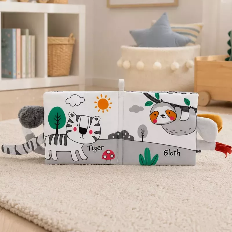 LEAN TOYS Minkštas sensorinis knygelė su ošiančiu ir cypiančiu drambliu, pilka